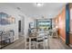 Bright dining and living area featuring a cozy atmosphere, hardwood floors, and natural lighting at 8313 Ocean Tides Cv, Parrish, FL 34219