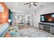 Open-concept living area flows into a dining space and features wood-look floors and an accent wall at 8313 Ocean Tides Cv, Parrish, FL 34219