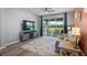 Inviting living room features sliding glass doors, ceiling fan, and a comfortable seating area at 8313 Ocean Tides Cv, Parrish, FL 34219