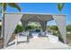 Comfortable outdoor lounge area with plush seating, shade, and lush landscaping at 8313 Ocean Tides Cv, Parrish, FL 34219