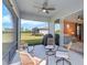 Covered patio boasts comfortable seating and a ceiling fan with views of the backyard at 8313 Ocean Tides Cv, Parrish, FL 34219