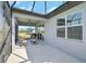 Screened-in lanai featuring a ceiling fan and views of the private backyard at 8313 Ocean Tides Cv, Parrish, FL 34219