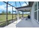 Screened-in lanai with ample seating and scenic backyard views, perfect for outdoor relaxation at 8313 Ocean Tides Cv, Parrish, FL 34219