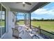 Inviting covered patio features cozy seating and serene views of the lush backyard at 8313 Ocean Tides Cv, Parrish, FL 34219