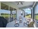 Covered patio offers scenic backyard views and comfortable seating for outdoor relaxation at 8313 Ocean Tides Cv, Parrish, FL 34219