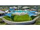 A sparkling blue resort-style pool, lounge chairs, shade structures, and lush landscaping at 8313 Ocean Tides Cv, Parrish, FL 34219
