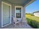 Inviting front porch with seating area perfect for enjoying warm days at 8313 Ocean Tides Cv, Parrish, FL 34219