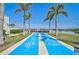 Outdoor shuffleboard court with lush landscaping and palm trees, providing recreational opportunities at 8313 Ocean Tides Cv, Parrish, FL 34219