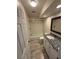 Bathroom with a tiled shower-tub, vanity with a granite countertop and a decorative mirror at 940 Byron Ct # 17C, Sarasota, FL 34243