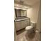 Updated bathroom with a granite-topped vanity and a modern toilet at 940 Byron Ct # 17C, Sarasota, FL 34243