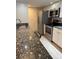 Galley kitchen with granite countertops and stainless steel appliances at 940 Byron Ct # 17C, Sarasota, FL 34243