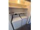 Laundry closet with a side by side washer and dryer and wire shelves at 940 Byron Ct # 17C, Sarasota, FL 34243