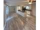 Expansive living space flowing into kitchen, featuring modern ceiling fans and wood look flooring at 940 Byron Ct # 17C, Sarasota, FL 34243