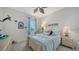 Bright bedroom featuring window, dresser, and bedside table with turquoise accents at 5356 Mang Pl # 1404, Sarasota, FL 34238