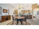Cozy dining area with adjacent kitchen and elegant chandelier at 5356 Mang Pl # 1404, Sarasota, FL 34238