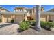 Attractive townhome featuring a two-car garage, lush landscaping, and a welcoming entrance at 5356 Mang Pl # 1404, Sarasota, FL 34238