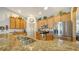 Kitchen with stainless steel appliances, granite countertops, and bright lighting at 5356 Mang Pl # 1404, Sarasota, FL 34238