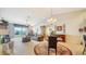 Elegant living room with neutral carpeting, chandelier and access to the balcony at 5356 Mang Pl # 1404, Sarasota, FL 34238