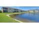 Scenic view of a community pond with lush green surroundings at 5356 Mang Pl # 1404, Sarasota, FL 34238