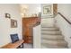 Staircase featuring carpeted stairs and wooden railing at 5356 Mang Pl # 1404, Sarasota, FL 34238