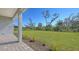 Lush backyard featuring green grass with patio area at 10027 Cross River Trl, Parrish, FL 34219