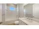 Bright bathroom with white vanity, tiled shower/tub with a window, a white toilet and wood look flooring at 10027 Cross River Trl, Parrish, FL 34219