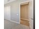 Spacious bedroom with walk-in closet featuring wood floors, light neutral walls and grey carpet at 10027 Cross River Trl, Parrish, FL 34219