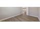 Bedroom view showcasing wood floors and an open door leading into the kitchen at 10027 Cross River Trl, Parrish, FL 34219