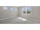 Bright, carpeted bedroom with multiple windows providing great natural light at 10027 Cross River Trl, Parrish, FL 34219