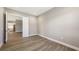 Neutral-toned bedroom with wood floors, and white trim leading to other rooms at 10027 Cross River Trl, Parrish, FL 34219