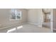 Well lit room with grey carpet, light walls, large window and glimpse of entry and bathroom at 10027 Cross River Trl, Parrish, FL 34219