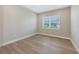Bright, airy bedroom with wood floors and a large window offering natural light at 10027 Cross River Trl, Parrish, FL 34219