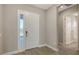 Inviting entryway featuring a white front door with sidelight and wood-look floors at 10027 Cross River Trl, Parrish, FL 34219