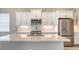 Kitchen featuring quartz counter tops, herringbone backsplash, stainless appliances and large central island at 10027 Cross River Trl, Parrish, FL 34219