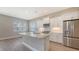 Bright kitchen features wood floors, stainless steel appliances, and a center island perfect for entertaining at 10027 Cross River Trl, Parrish, FL 34219