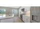 Well lit kitchen featuring stainless appliances, quartz counters, central island, and view to the outside at 10027 Cross River Trl, Parrish, FL 34219