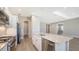 Open kitchen with stainless appliances and large central island has beautiful wood flooring and great natural light at 10027 Cross River Trl, Parrish, FL 34219