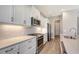 Modern kitchen features white cabinetry, quartz countertops, herringbone backsplash, and stainless steel appliances at 10027 Cross River Trl, Parrish, FL 34219