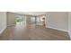 Open-concept living area showcasing wood-look floors, recessed lighting, and sliding glass doors to the backyard at 10027 Cross River Trl, Parrish, FL 34219