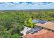 Lovely aerial view of an estate with beautiful landscaping surrounding a tranquil lake at 11551 30Th E Cv, Parrish, FL 34219