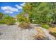 Landscaped backyard, showing decorative stones, small trees, and stone pathway at 11551 30Th E Cv, Parrish, FL 34219