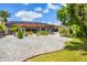 Spacious backyard featuring a screened-in patio, decorative rock garden, and lush green lawn at 11551 30Th E Cv, Parrish, FL 34219