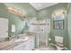 Bathroom featuring granite countertops, modern fixtures, and a glass-enclosed shower at 11551 30Th E Cv, Parrish, FL 34219