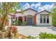 Beautifully landscaped home exterior featuring a circular driveway, decorative accents, and mature plantings at 11551 30Th E Cv, Parrish, FL 34219
