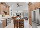 Large kitchen with custom cabinets, stainless steel appliances, an island, and views to other rooms at 11551 30Th E Cv, Parrish, FL 34219