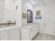 Well-organized laundry room with white cabinetry, marble countertop, and modern washer and dryer units at 11551 30Th E Cv, Parrish, FL 34219