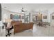 Open-concept living room flowing into the dining area with a view of the screened-in pool at 11551 30Th E Cv, Parrish, FL 34219