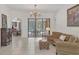 Welcoming living room with tiled floors, sliding glass doors to screened-in pool, and classic decor at 11551 30Th E Cv, Parrish, FL 34219
