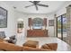 Bright living room with media center, tiled floors, and access to the screened-in pool area at 11551 30Th E Cv, Parrish, FL 34219