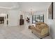 Bright living room with tile flooring, a chandelier, and sliding doors to the pool area at 11551 30Th E Cv, Parrish, FL 34219